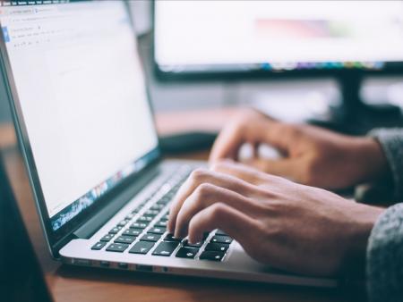 Man typing on laptop