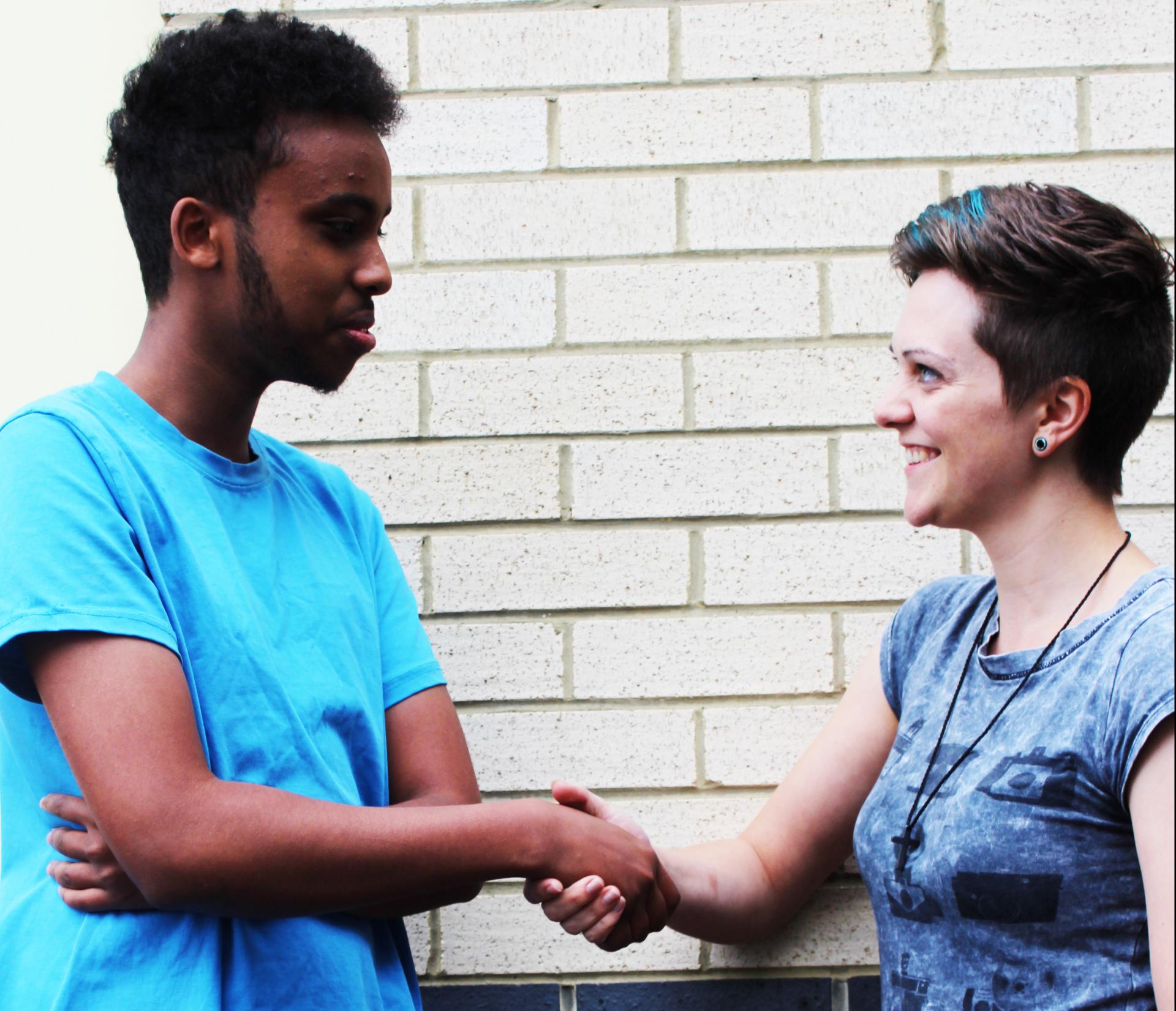 Abdi and Naomi shaking hands