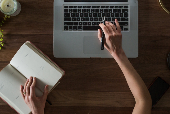 Hand typing on laptop