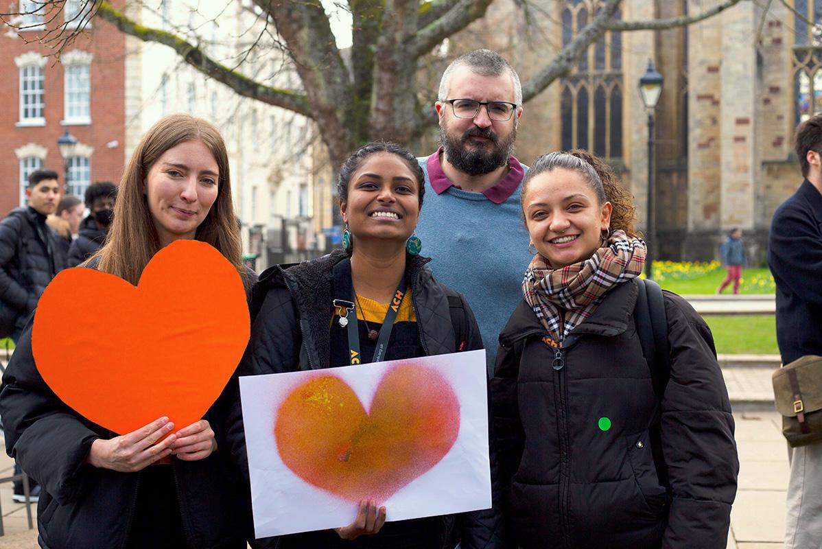 Picture of ACH team holding orange hearts