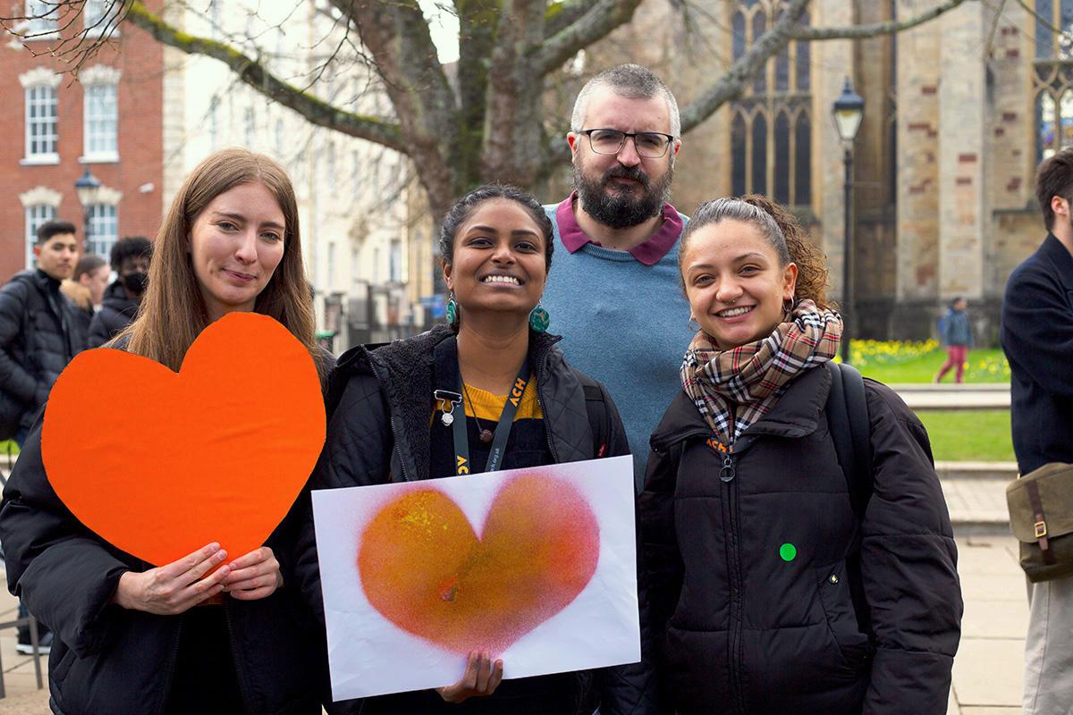 ACH team holding orange hearts