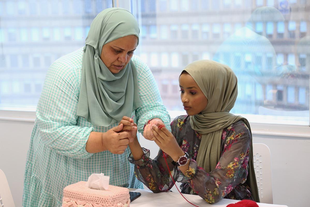 Two people crocheting