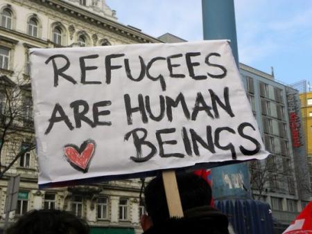 a banner that says refugees are human beings