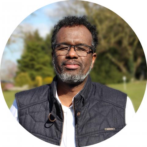 A headshot of Abdi Mohamed who has experience in refugee integration and employment in Bristol